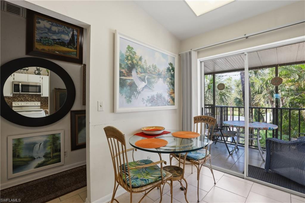 4050 Ice Castle Way, Unit 2812 Naples, FL 34112 - Photo 6 of 49 Dining area featuring tile flooring, a glass-top table, and direct access to a screened outdoor space