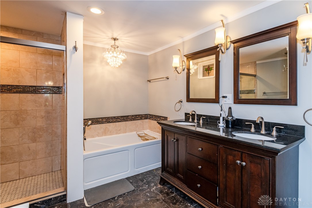 728 Chipplegate Drive Centerville, OH 45459 - Photo 17 of 30 This primary bathroom offers a double vanity, a soaking tub, and a shower with elegant tile work.