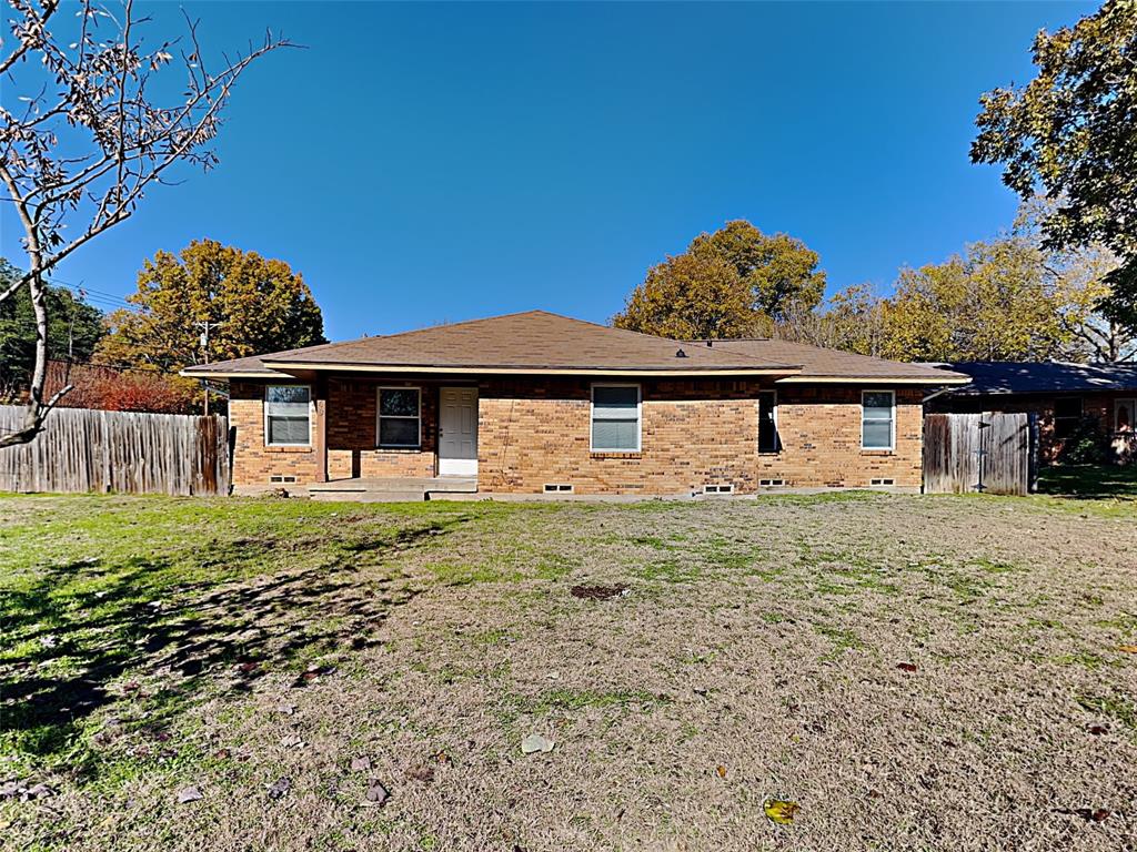 Rear view of house with brick siding and covered porch