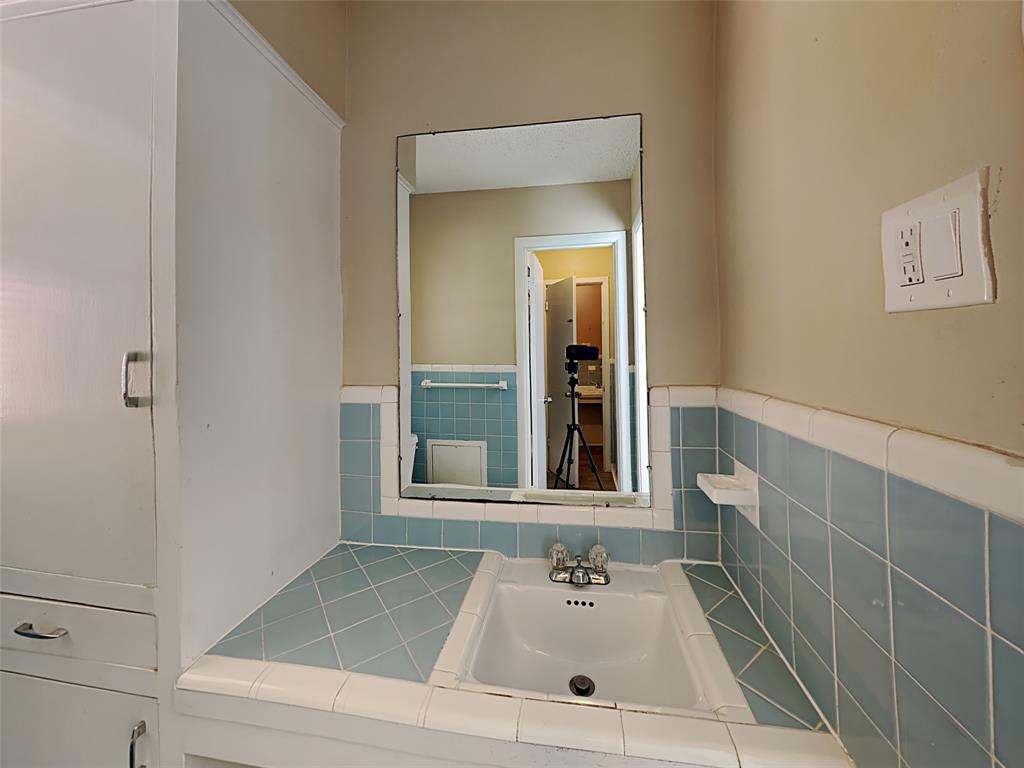 649 West Main Street Lancaster, TX 75146 - Photo 2 of 14 Bathroom featuring a sink and tile walls