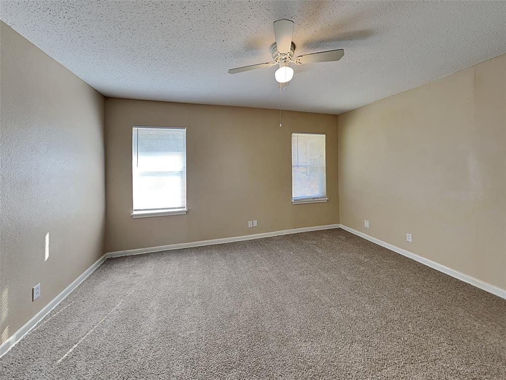649 West Main Street Lancaster, TX 75146 - Photo 5 of 14 Unfurnished room featuring light carpet, a textured ceiling, and a ceiling fan