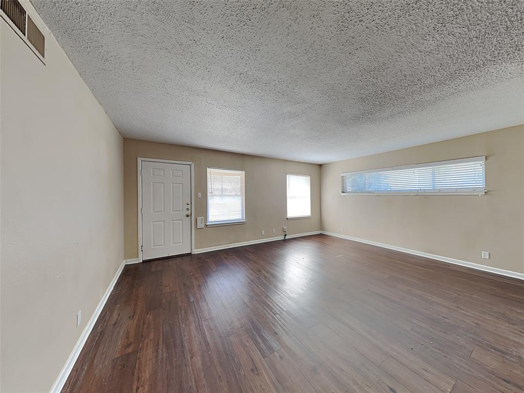 649 West Main Street Lancaster, TX 75146 - Photo 10 of 14 Entrance foyer featuring a textured ceiling and dark wood-type flooring