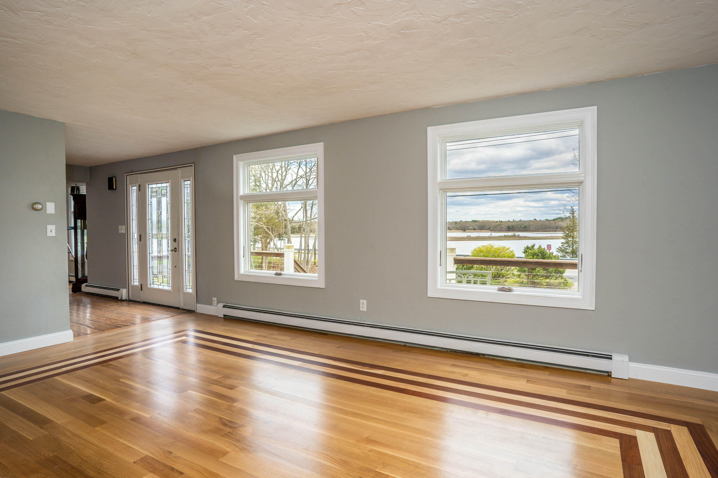 268 Shore Road Buzzards Bay, MA 02532 - Photo 8 of 36 a view of an empty room with wooden floor and a window