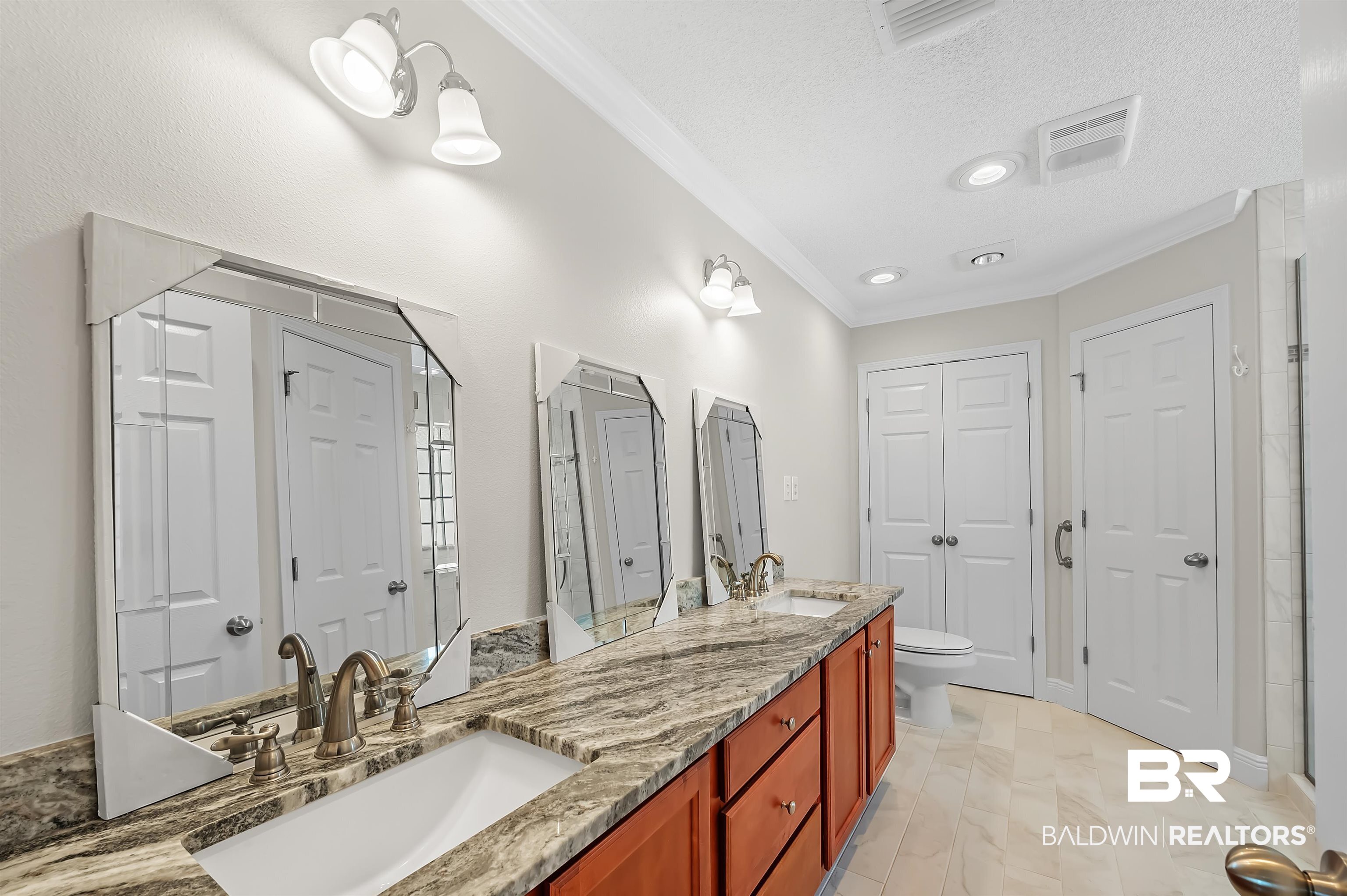421 Collinwood Loop Foley, AL 36535 - Photo 37 of 62 Bathroom with vanity, ornamental molding, a textured ceiling, and toilet