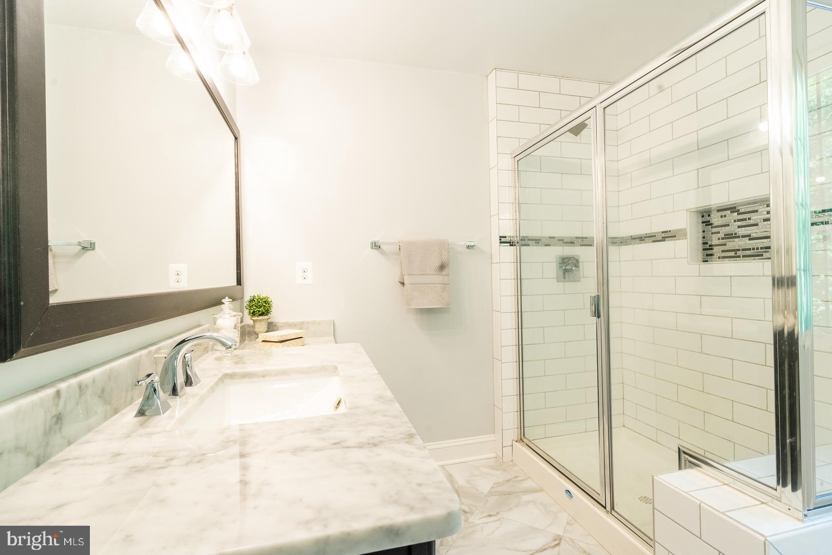 5705 Solomons Island Road St. Leonard, MD 20685 - Photo 4 of 46 a bathroom with a granite countertop sink and a mirror