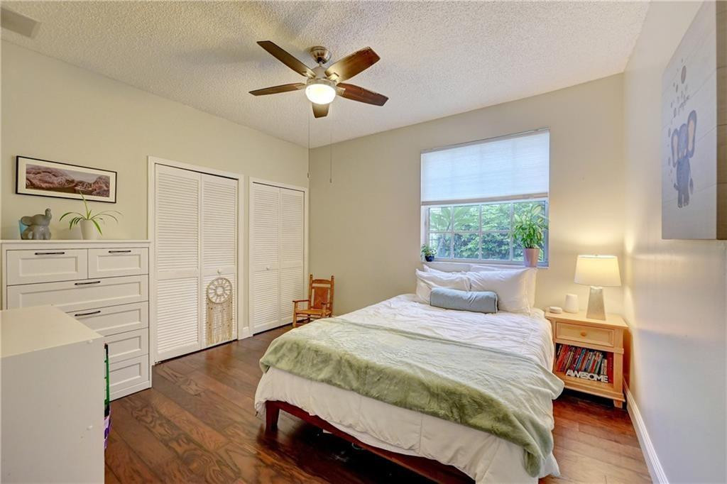 8171 Hampton Wood Drive Boca Raton, FL 33433 - Photo 11 of 56 a bedroom with a large bed and a window