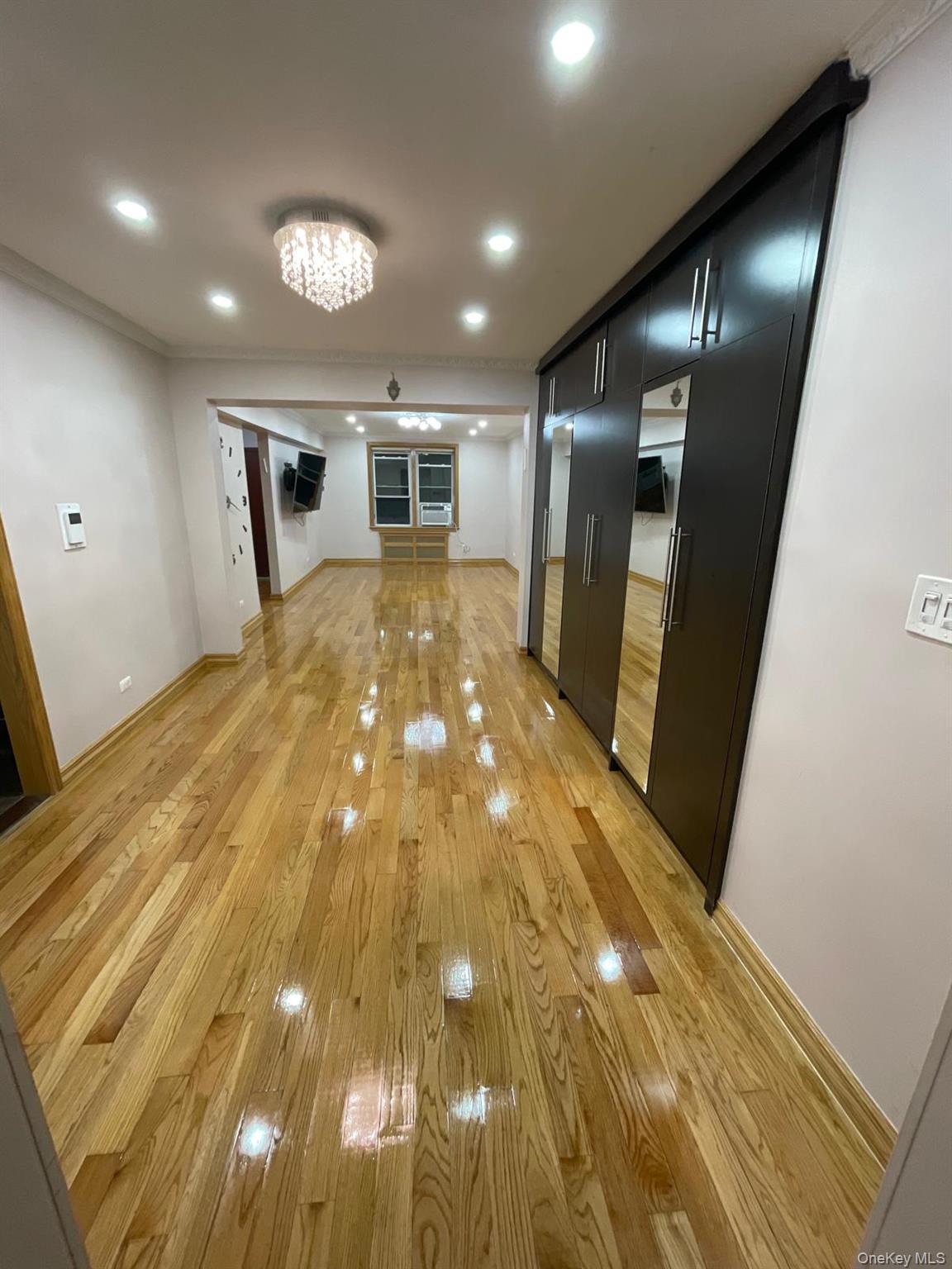 105-25 65th Avenue, Unit 5H Queens, NY 11375 - Photo 2 of 6 Hall featuring light wood-style floors, recessed lighting, and crown molding