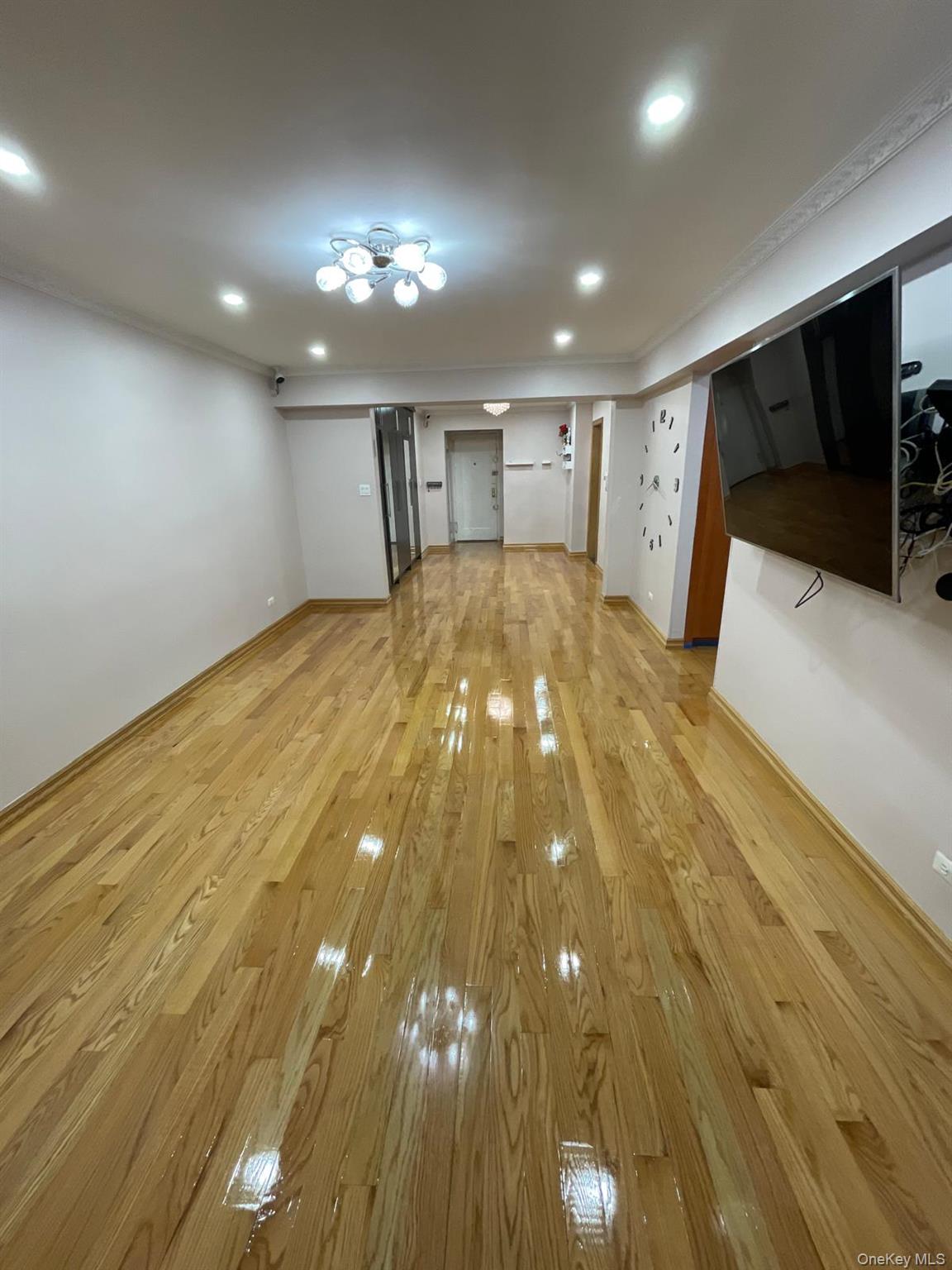 105-25 65th Avenue, Unit 5H Queens, NY 11375 - Photo 5 of 6 Unfurnished living room with light wood-style floors and recessed lighting