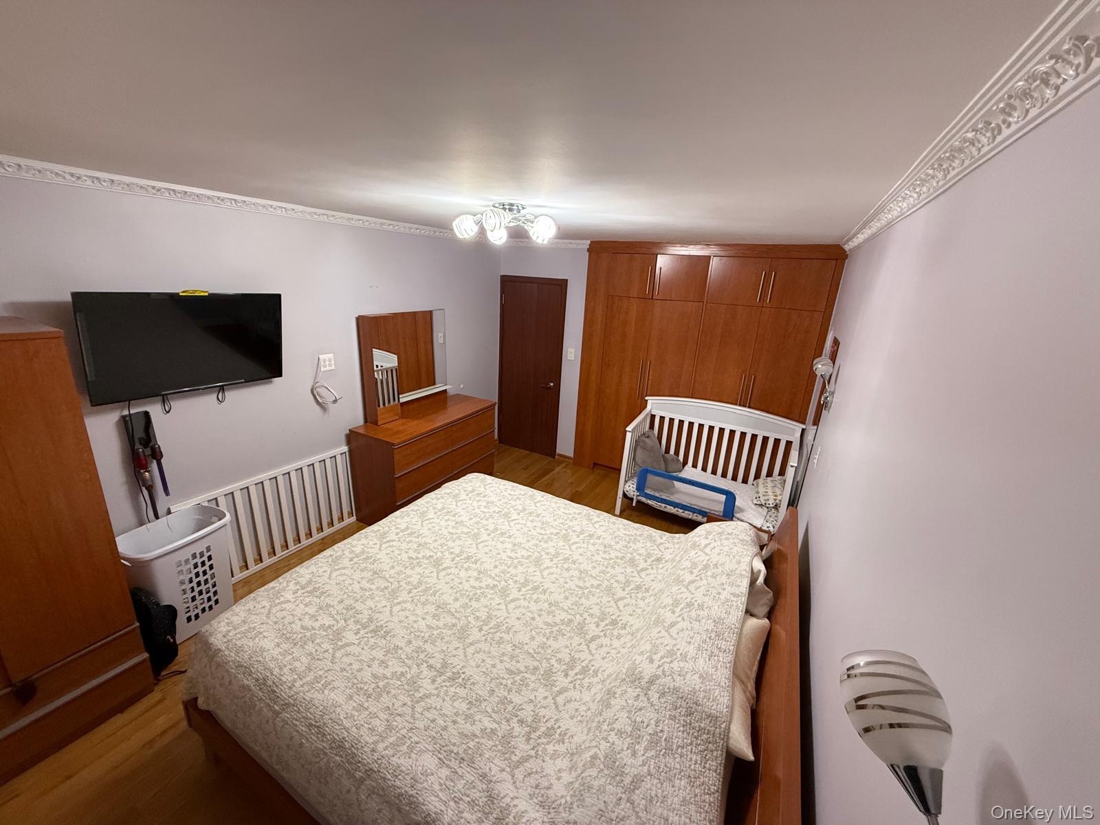 105-25 65th Avenue, Unit 5H Queens, NY 11375 - Photo 6 of 6 Bedroom featuring ornamental molding and wood finished floors