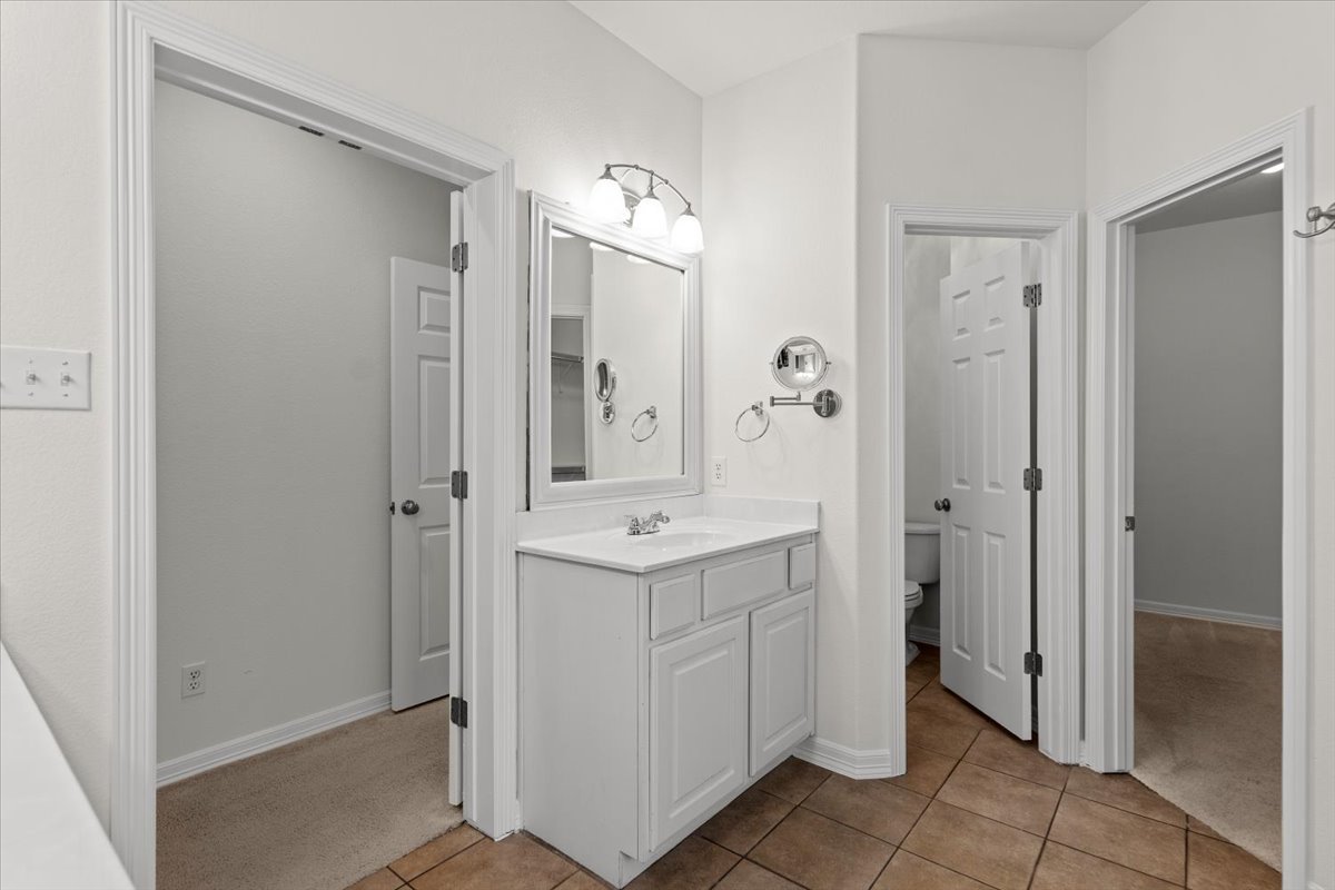 2304 Village View Loop Pflugerville, TX 78660 - Photo 29 of 40 Functional vanity with ample storage and bright lighting, perfect for daily routines.
