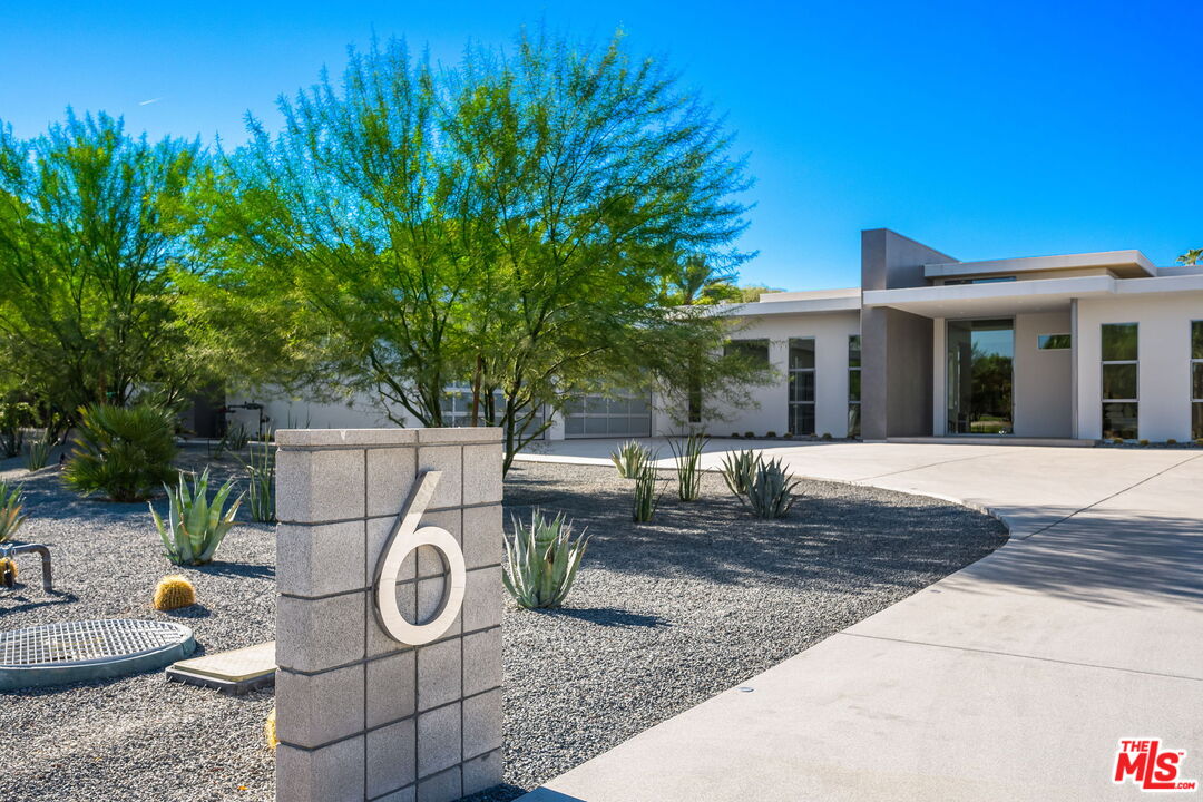 6 Big Sioux Road Rancho Mirage, CA 92270 - Photo 1 of 1 a view of a patio with table and chairs potted plants and large tree