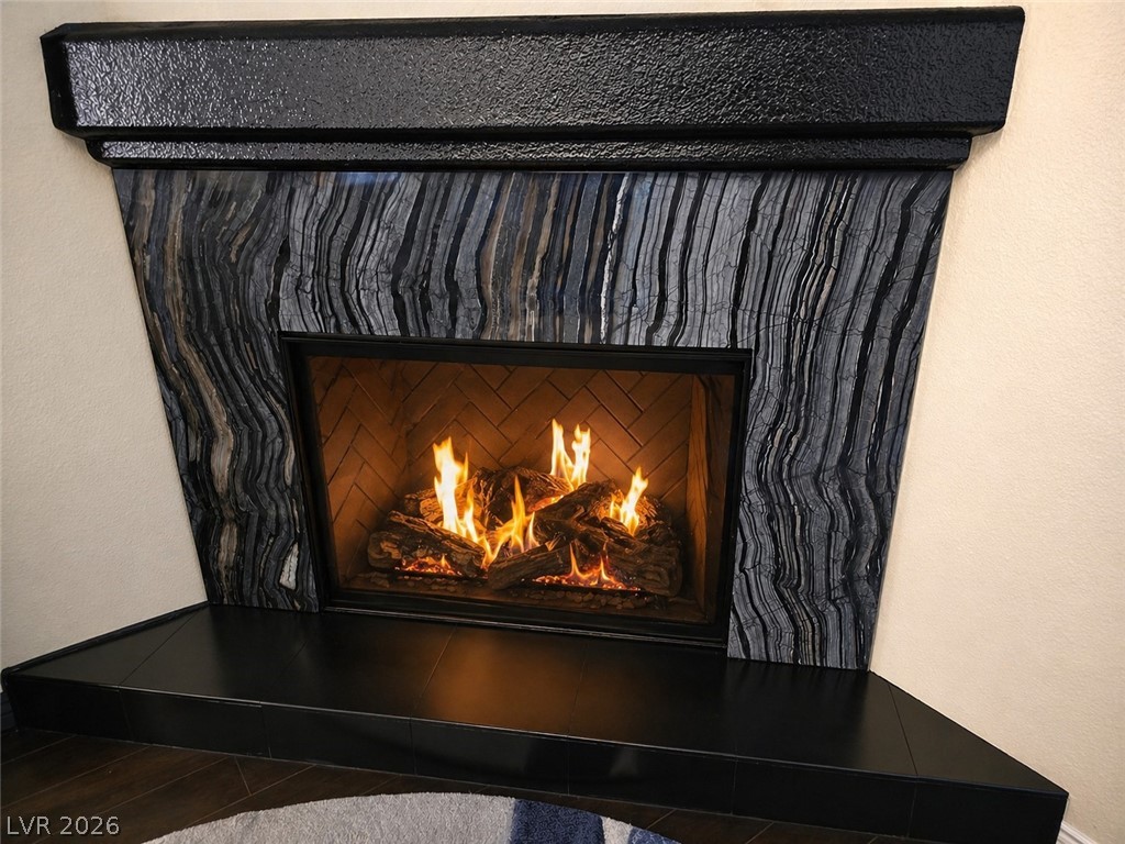 2050 West Warm Springs Road, Unit 2422 Henderson, NV 89014 - Photo 4 of 44 This living room features a cozy fireplace, ideal for relaxation and warmth.