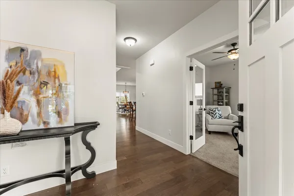 a view of a hallway with workspace and living room