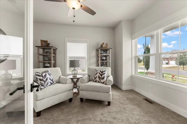 a living room with furniture a clock and a window