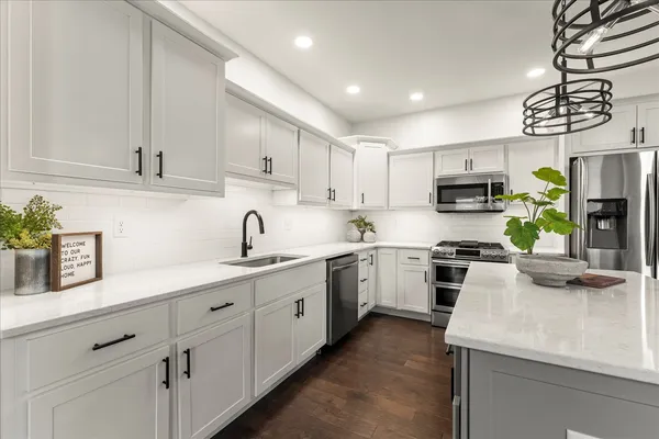 a large white kitchen with lots of counter top space