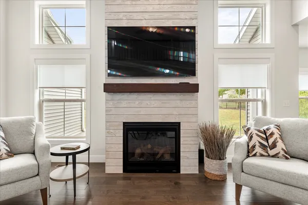 a living room with furniture a fireplace and a flat screen tv