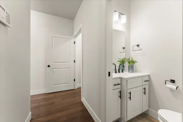 a bathroom with a tub sink double vanity and mirror