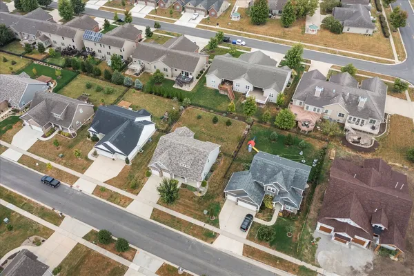 an aerial view of residential houses with outdoor space