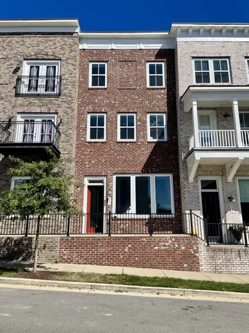 a front view of a brick house with a yard