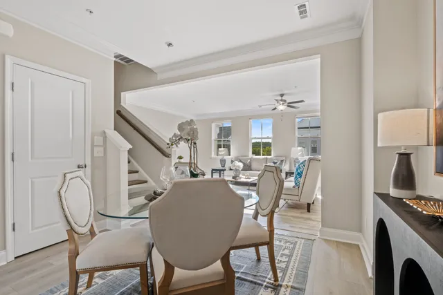 a living room with furniture a chandelier and a window