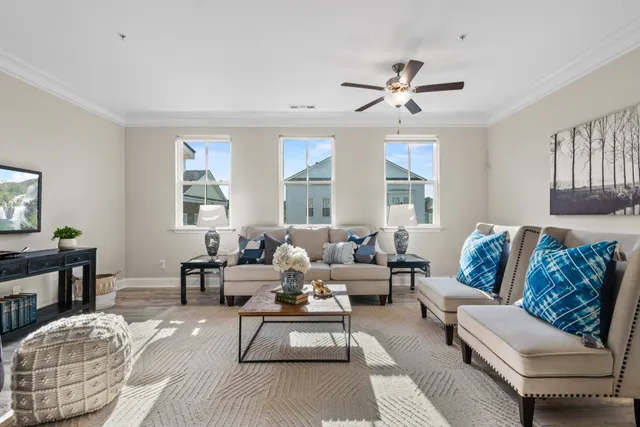 a living room with furniture and a wooden floor