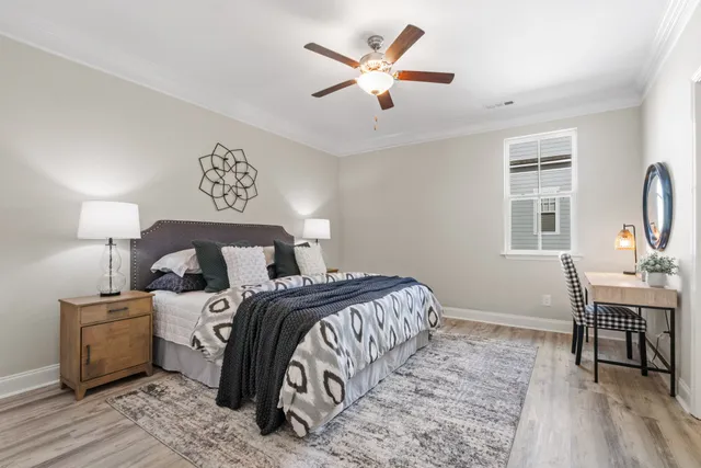 a bedroom with a bed and a chandelier