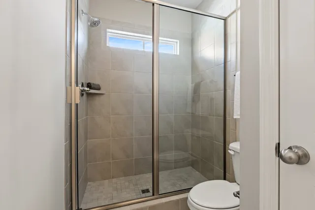 a bathroom with a double vanity sink and mirror with shower