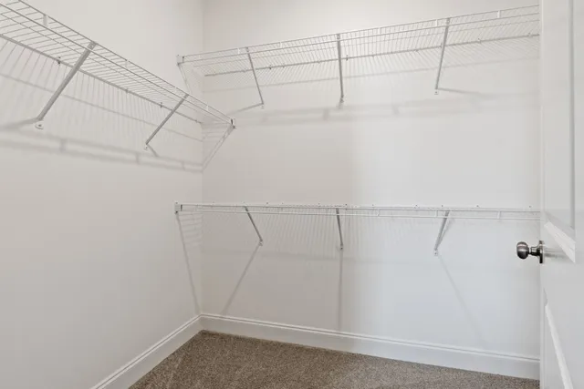 an empty room with a window and a ceiling fan