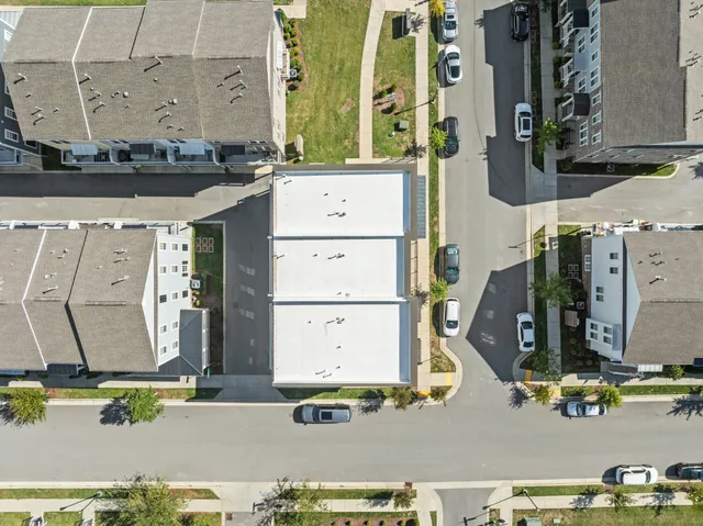 an aerial view of a residential apartment building with a city view