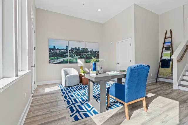 a dining room with furniture a chandelier and wooden floor