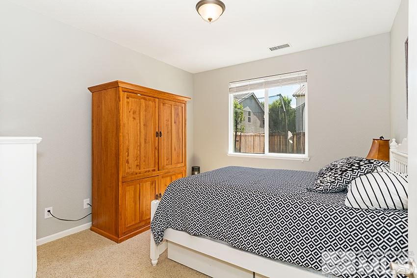 11190 Messina Way Reno, NV 89521 - Photo 17 of 21 a bedroom with a bed and a window