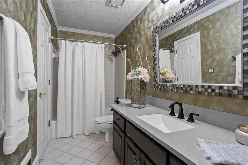 4350 Fallowfield Lane Southwest Lilburn, GA 30047 - Photo 18 of 64 a bathroom with a granite countertop sink a toilet and a mirror