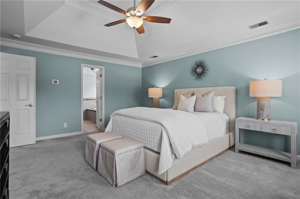 4350 Fallowfield Lane Southwest Lilburn, GA 30047 - Photo 20 of 64 a bedroom with a bed and a chandelier