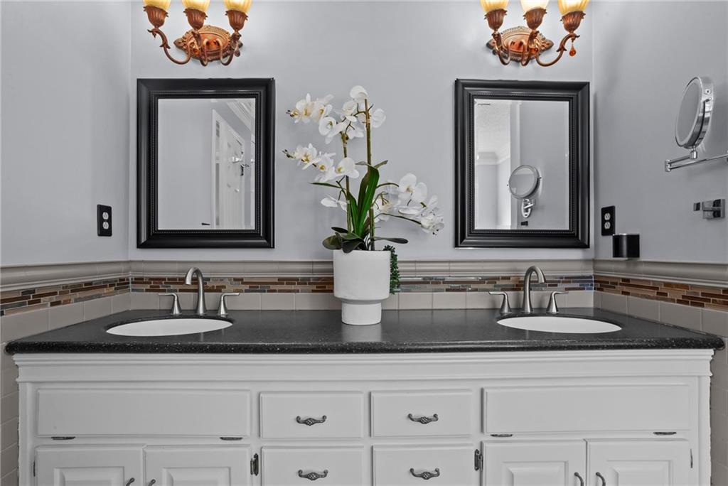 4350 Fallowfield Lane Southwest Lilburn, GA 30047 - Photo 23 of 64 a bathroom with sink two sinks and a mirror