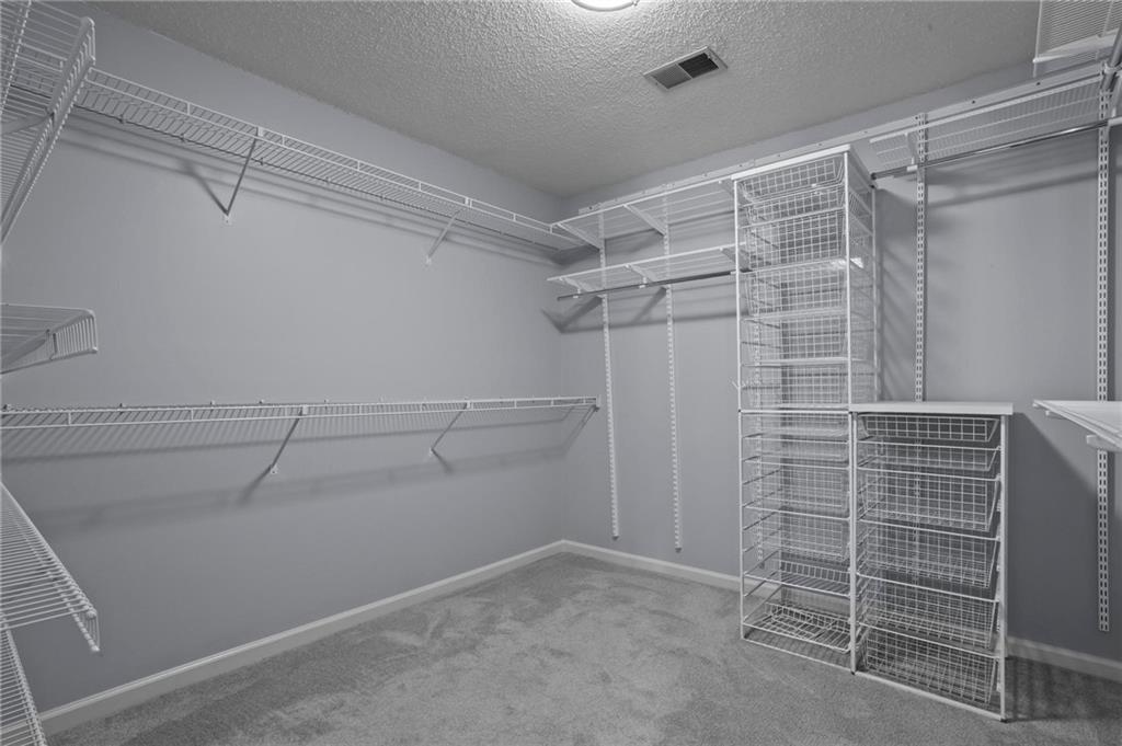 4350 Fallowfield Lane Southwest Lilburn, GA 30047 - Photo 25 of 64 a view of walk in closet with empty racks