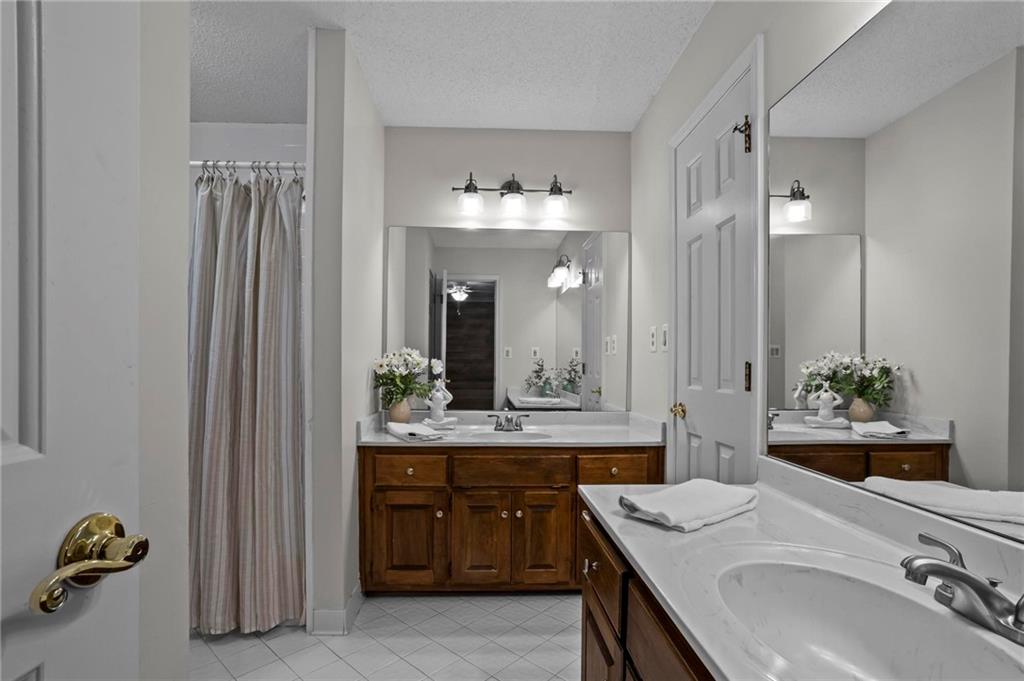 4350 Fallowfield Lane Southwest Lilburn, GA 30047 - Photo 29 of 64 a bathroom with a sink double vanity and a mirror
