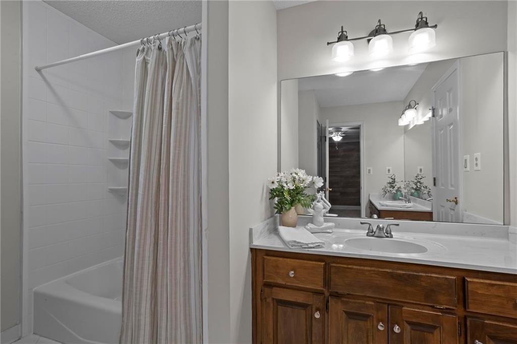 4350 Fallowfield Lane Southwest Lilburn, GA 30047 - Photo 30 of 64 a bathroom with a sink and a mirror