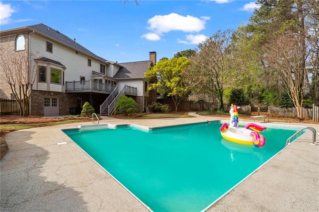 4350 Fallowfield Lane Southwest Lilburn, GA 30047 - Photo 49 of 64 a view of a backyard with swimming pool