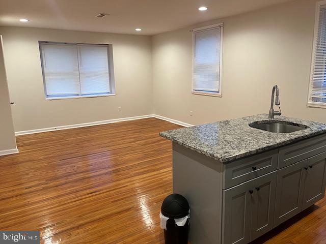5221 North 8th Street Philadelphia, PA 19120 - Photo 4 of 13 a kitchen with granite countertop sink and cabinets