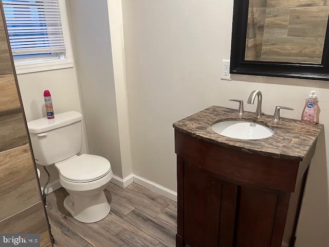 5221 North 8th Street Philadelphia, PA 19120 - Photo 10 of 13 a bathroom with a granite countertop toilet sink and mirror