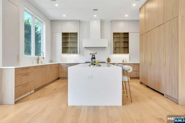 a kitchen with a sink a window and cabinets