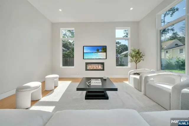 a living room with furniture couches and a large window