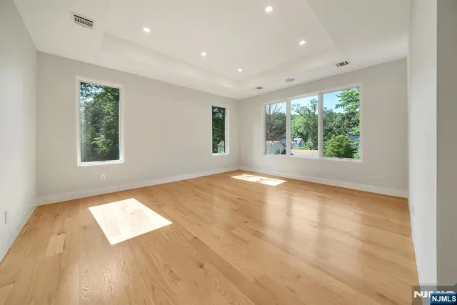 a spacious bathroom with a double vanity sink a mirror and a bathtub