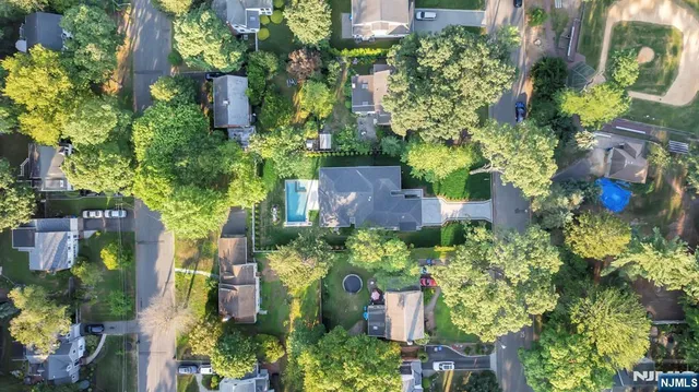 front view of a house with a yard and flowers
