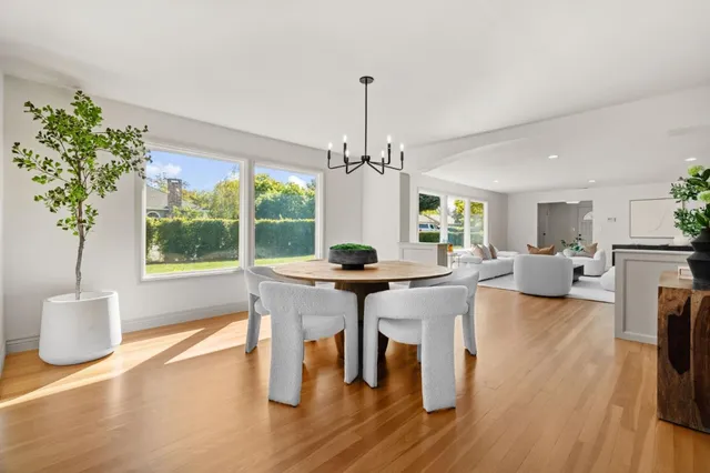 a living room with furniture a window and a chandelier