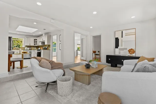 a living room with fireplace furniture and a table