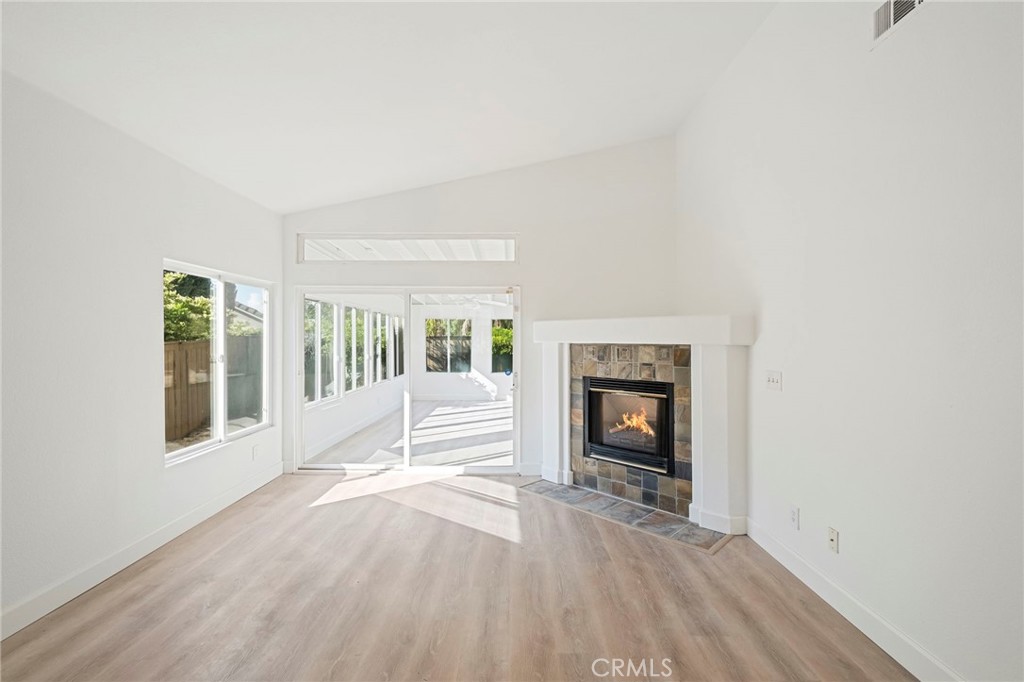 33298 Ave Bicicleta Temecula, CA 92592 - Photo 12 of 42 a view of an empty room with wooden floor fireplace and a window