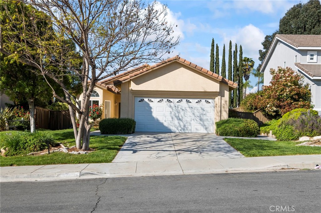 33298 Ave Bicicleta Temecula, CA 92592 - Photo 4 of 42 a front view of a house with a yard and garage