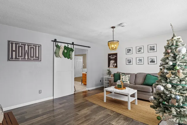 a living room with furniture and paintings on the wall