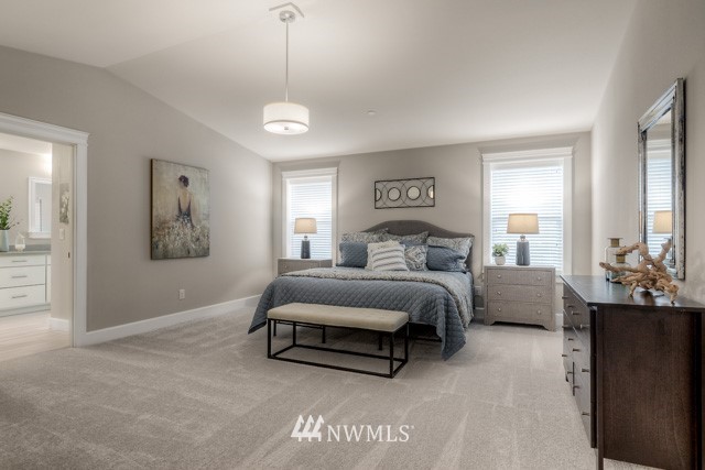 23226 7th Drive Southeast Bothell, WA 98021 - Photo 13 of 24 a spacious bedroom with a bed and a chandelier